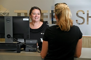 Council front counter staff with customer