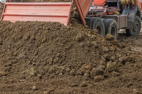 Dump truck unloading soil