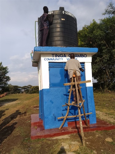 Painting the Tinga Obambo community water point.