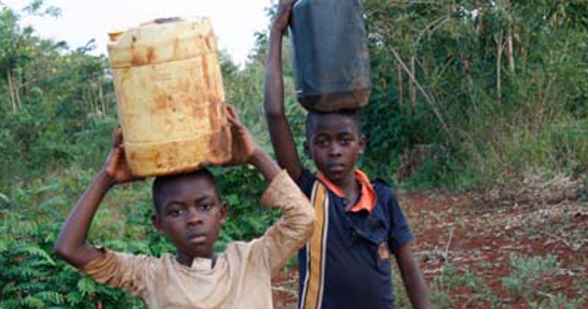 TKMP children carrying water