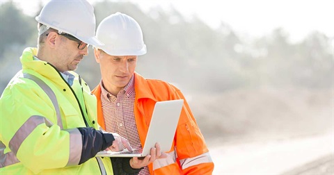 Workmen on site with laptop