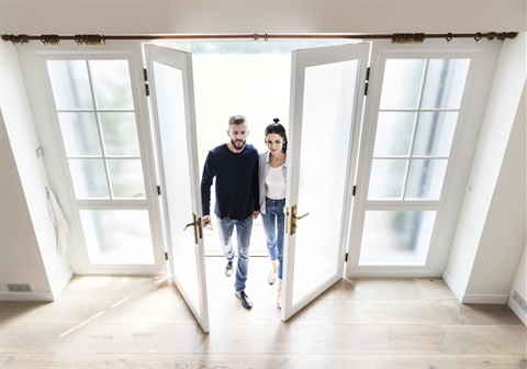 Couple entering new home